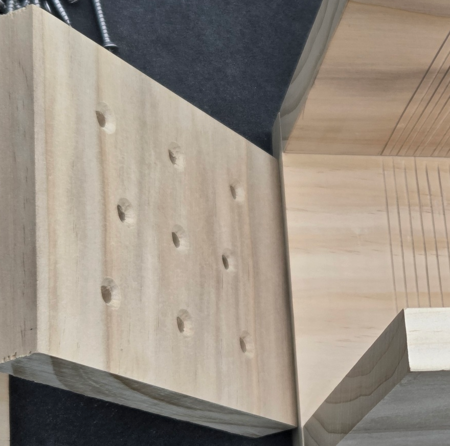 Wooden board with several drilled and countersunk holes