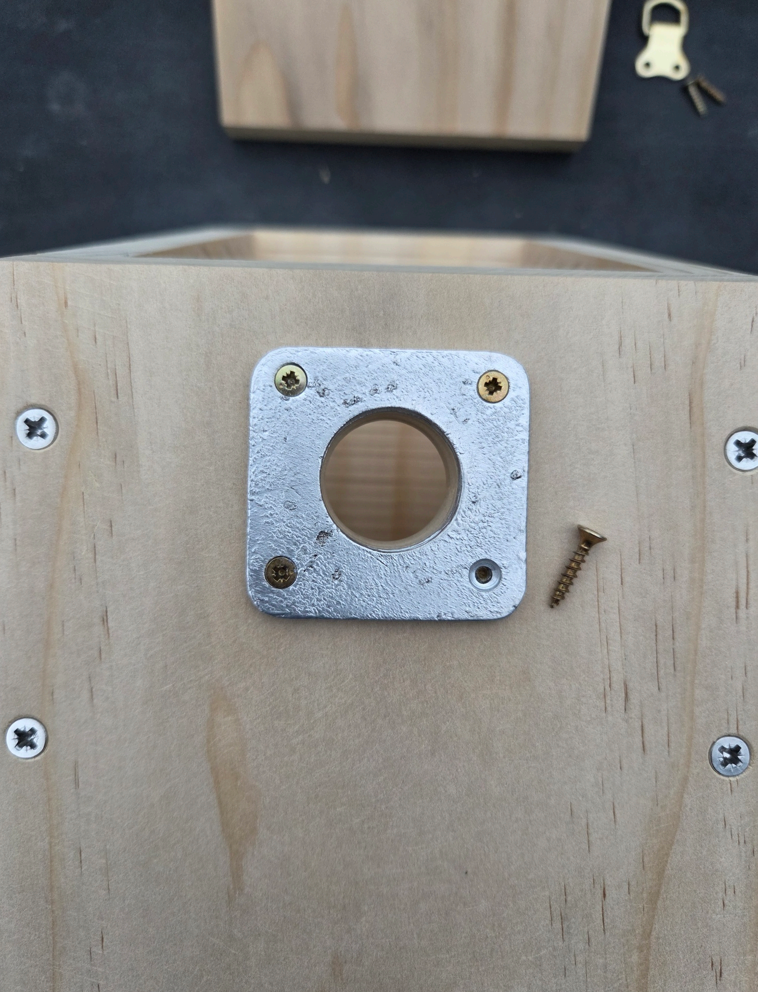 Close-up of the front of the nest box with a metal hole protector plate installed