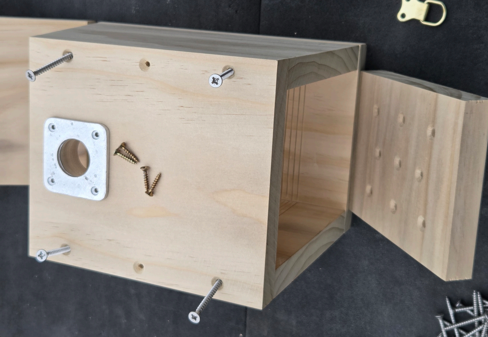 Box assembled with the metal hole-protector plate and a separate roof piece beside it